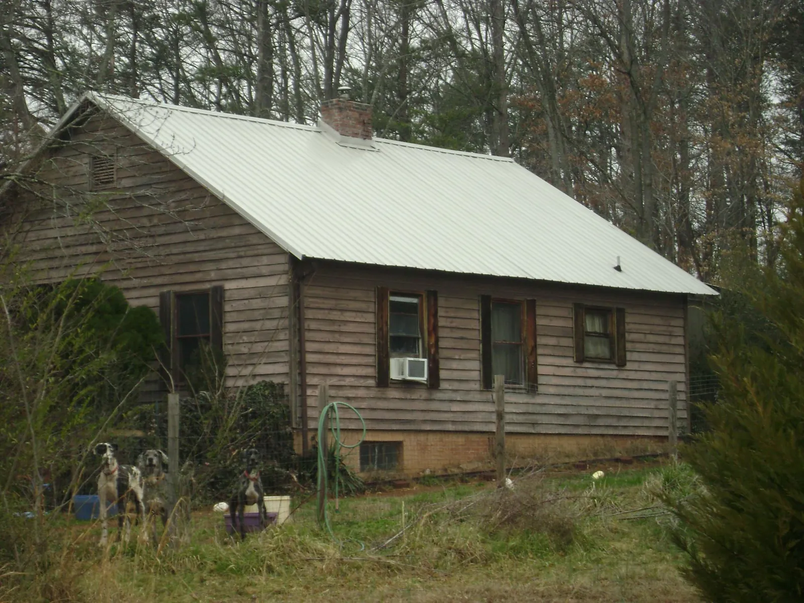 White metal roof on an old wood sided farmhouse, from a Metal Roof Installation job in Keene